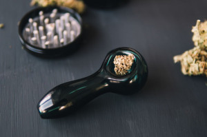 CBD and THC in cannabis buds. Weed smoking pipe. Cannabis buds